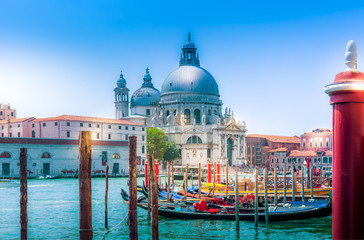 Fototapeta na wymiar Venice view on church Basilica di Santa Maria della Salute and canal with gondolas