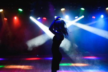 Fototapeta na wymiar dancing silhouette of girl in a nightclub