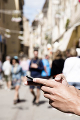 man using smartphone on the street.