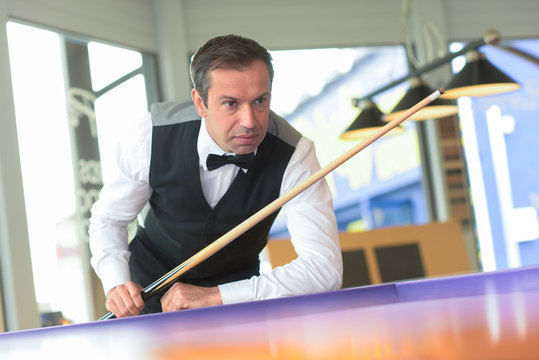 Snooker player contemplating next shot