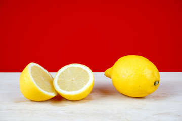 Lemon slices over red background. Space for text. Selective focus