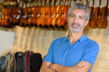 Aluminium Prints Music store man posing in a violin store