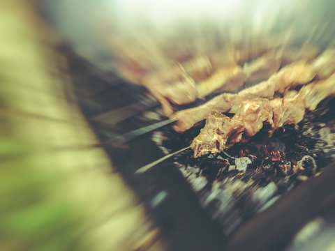 Mcvadi - shashlik preparing on a barbecue grill over charcoal. Roasted stacked meat traditional cuisine in Georgia