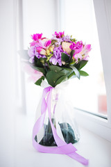 Purple bouquet on the window