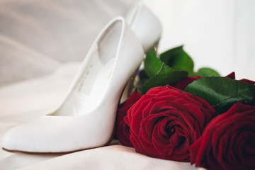 white wedding shoes and rose