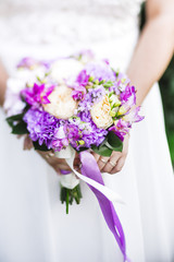 Purple bouquet with wedding dress