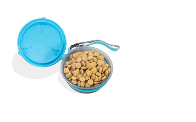 Bowl with dry food for dog or cat on isolated white.