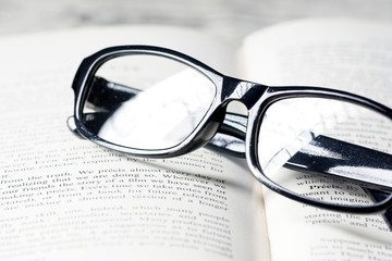 An eyeglasses and a book