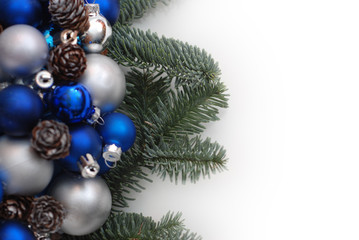 Obraz na płótnie Canvas Christmas Wreath with Fir Branches. blue and Silver Balls or Cristmas Globes Decorated with Pinecones. Isolated with Copy Space.