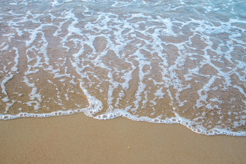 Fototapeta na wymiar The sea waves on the beach in the morning, the sun is not soft focus
