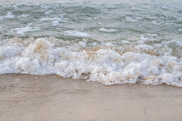 The sea waves on the beach in the morning, the sun is not soft focus