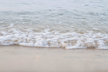 The sea waves on the beach in the morning, the sun is not soft focus