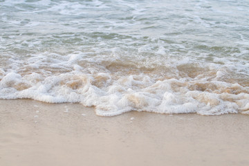 The sea waves on the beach in the morning, the sun is not soft focus