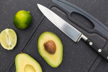 Avocado lime on chopping board with knife
