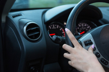 Fototapeta premium hand on steer wheel adjusting commands