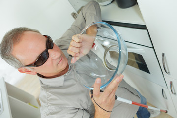 blind man in a kitchen at home