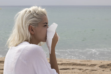 Cough using a handkerchief of a sick woman
