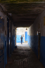silhouette of a boy on the narrow street of Essaouira