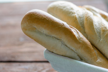 fresh baguettes close-up on wooden background
