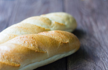 fresh baguettes close-up on wooden background