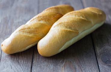 fresh baguettes close-up on wooden background