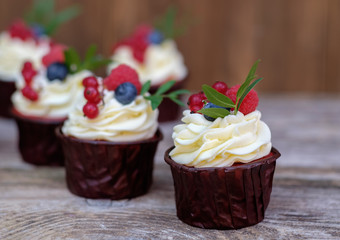 homemade cupcakes with pink cream and raspberry