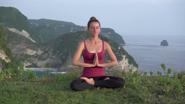 Woman meditates in yoga asana Padmasana