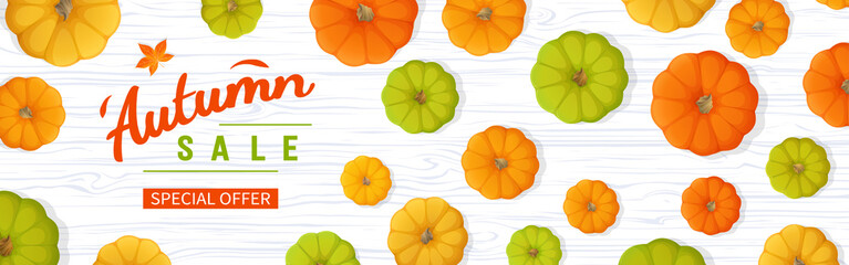 Web banner for Autumn sale. Horizontal banner flyer with yellow, green, orange pumpkins, leaves on a white wooden table. Special seasonal offer. Top view. Vector illustration.