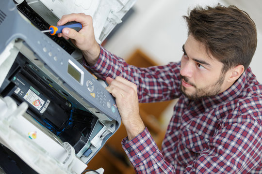 Technician working on printer
