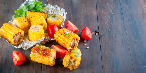 Pieces of sweet corn grilled in tin foil