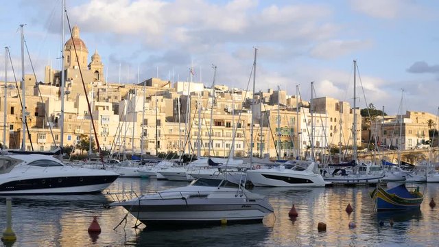 Birgu, Malta buildings architecture and yachts moored to the marina quay in morning