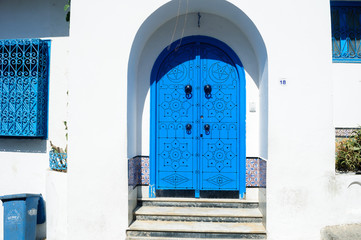 Decorative blue entrance door to the white house Sidi Bou Said.