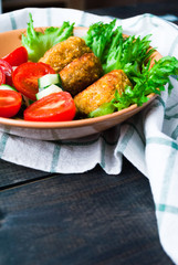 Fried chickpea falafel and fresh vegetable salad