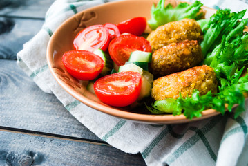 Fried chickpea falafel and fresh vegetable salad