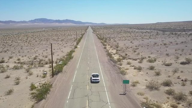 Driving on a lonesome road in the middle of nowhere aerial view