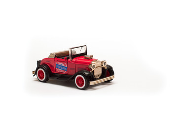 Red retro car, toy model on white background 