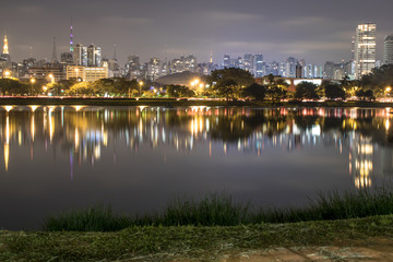 Fototapeta na wymiar Sao Paulo, Brazil. June 02, 2017: Night view lake in Ibirapuera Park and Sky line of city in Sao Paulo.