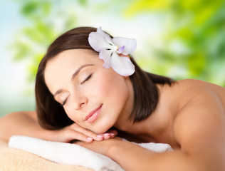 Obraz na płótnie Canvas wellness, spa and beauty concept - close up of beautiful woman over green natural background