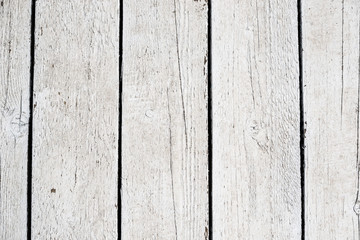 White texture of wooden boards with black slits close-up