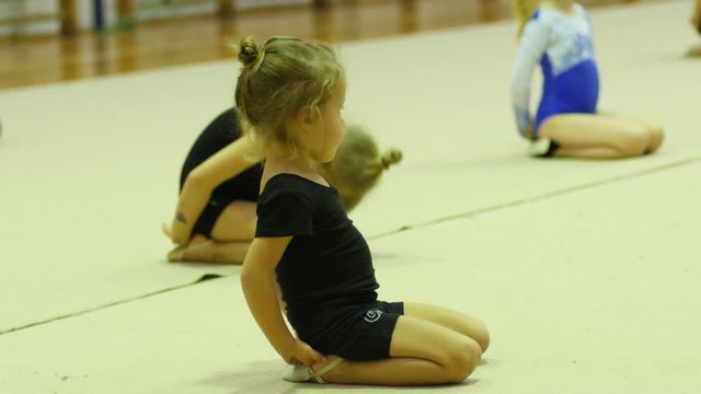 Children gym class for girls - a funny trying make dance gymnastics movements