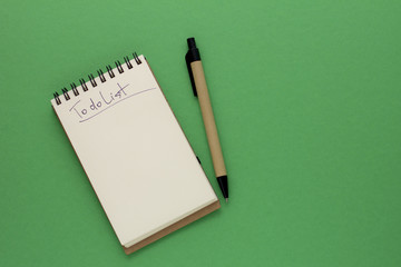 Pen and Notepad on the green background. To Do List