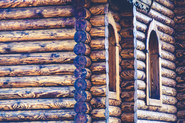Fragment of a log house with elements of Russian architecture, wooden carvings