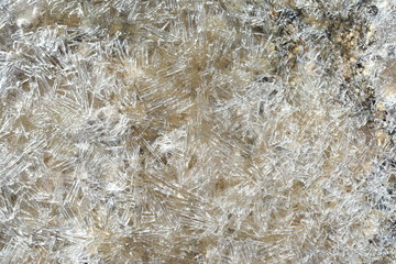 Ice Crystals on frozen pond. Close-up Ice pattern in puddle. Winter background