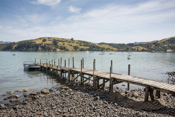 Akaroa New Zealand January 4th 2015 : Old wooden pier at Akaroa near Christchurch, New Zealand