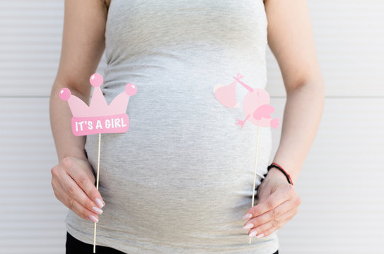 Pregnant woman with announcement props