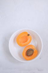 Apricots cuted and uncuted isolated on white background Healthy eating Weight loss Summer fruit concept Harvesting Organic fruits Copy space