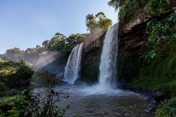 Fototapeta na wymiar Two waterfalls next to each other forming a pond