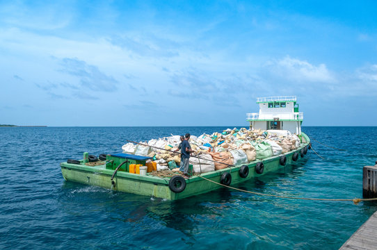 Trash boat on Maldives. How they handle garbage on islands. Peak up boat with the garbage from tourists.
