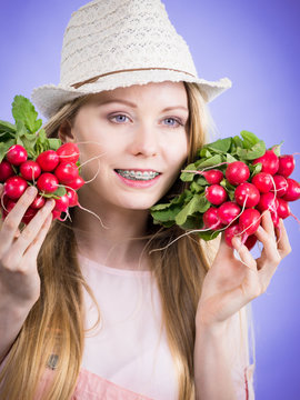 Young woman holding radish