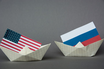 paper ship with Flags of USA and Russia. conflict  concept shipment or free trade agreement and...